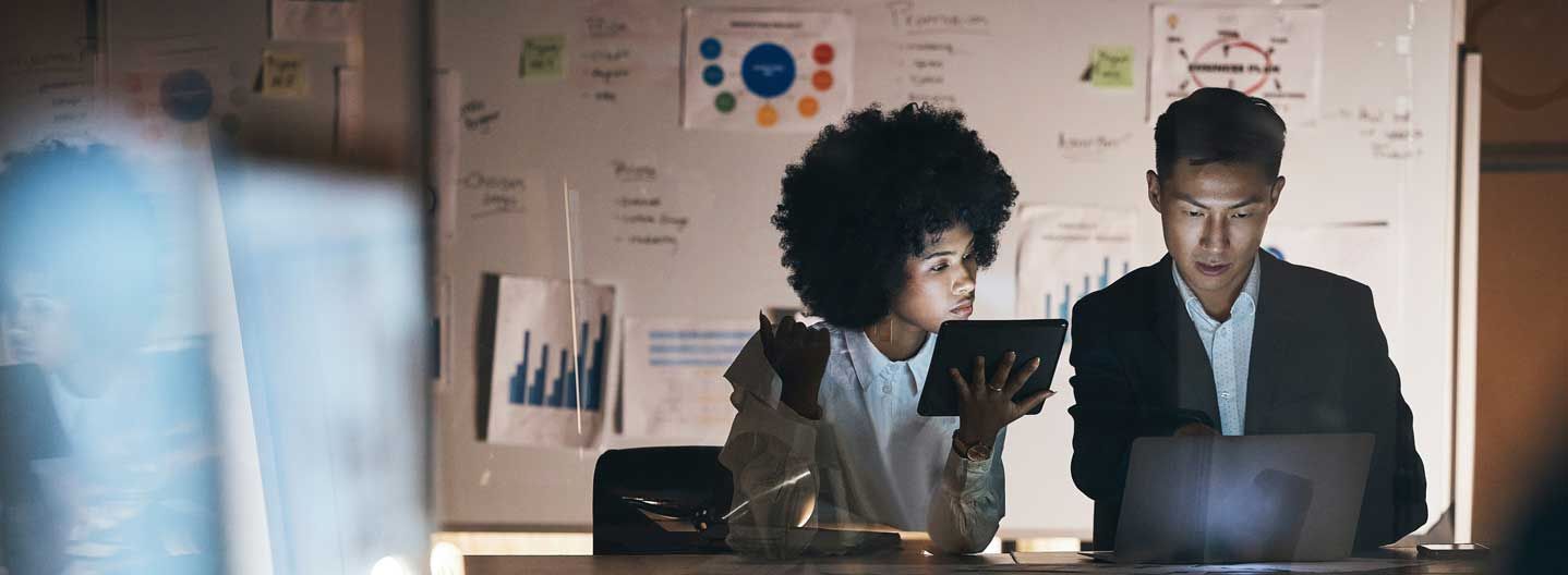 Two people talking with computer