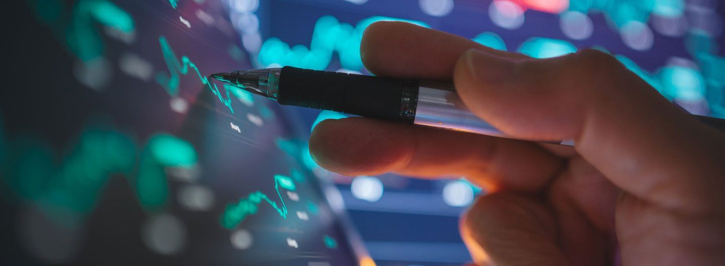 Hand with stylus on computer screen