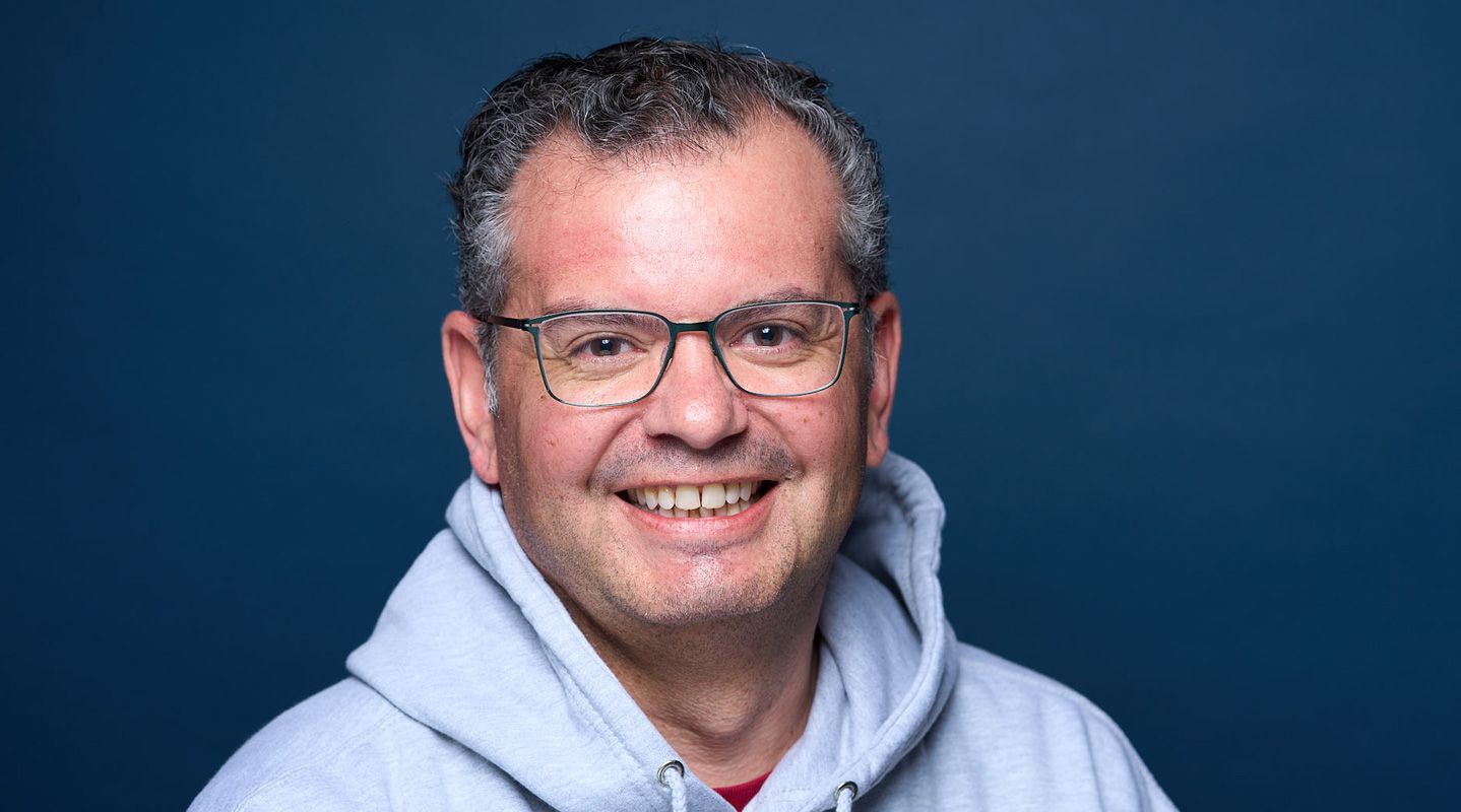 Man smiling on blue background