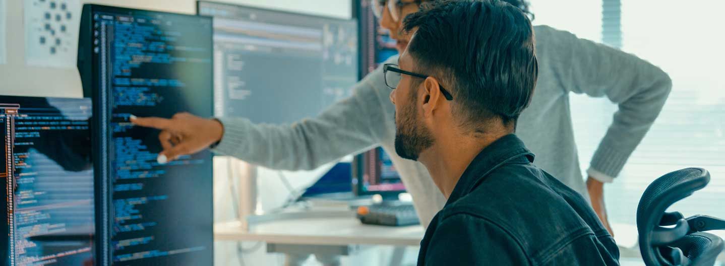 Man at screen with lady pointing something out