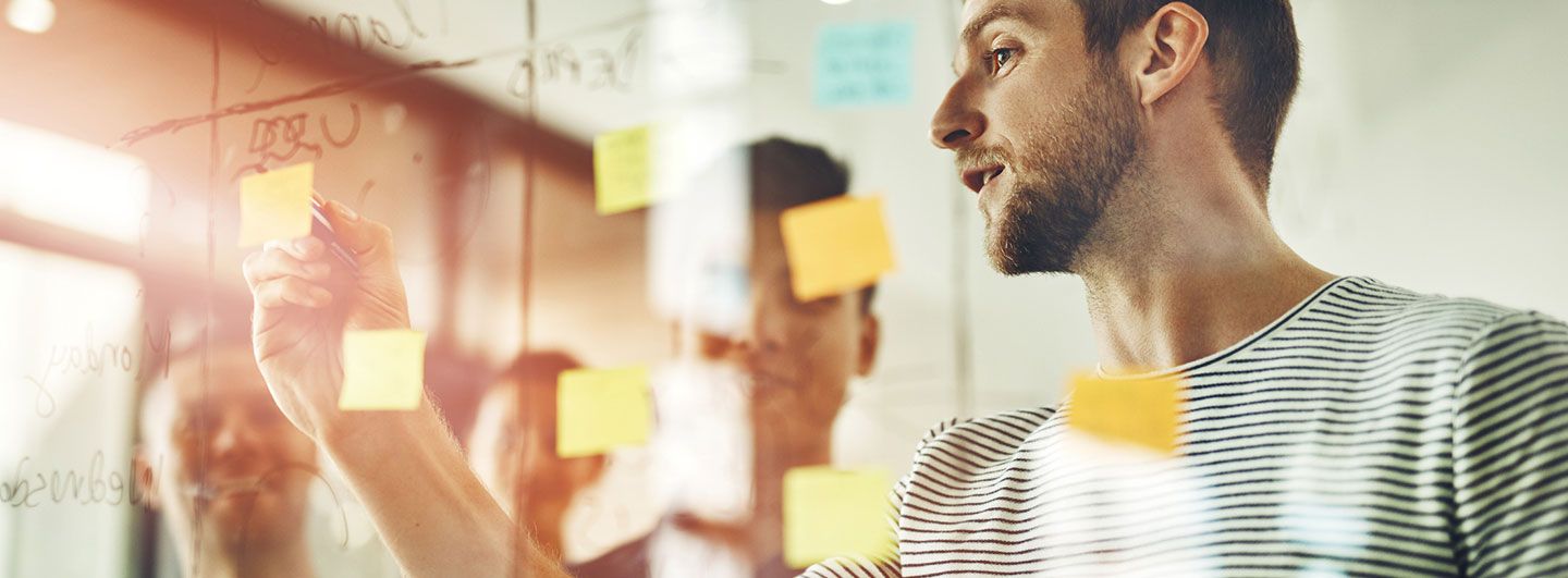 Man planning with Post-it notes