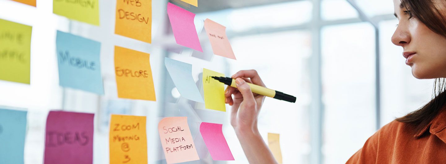 Women writing on Post-it notes