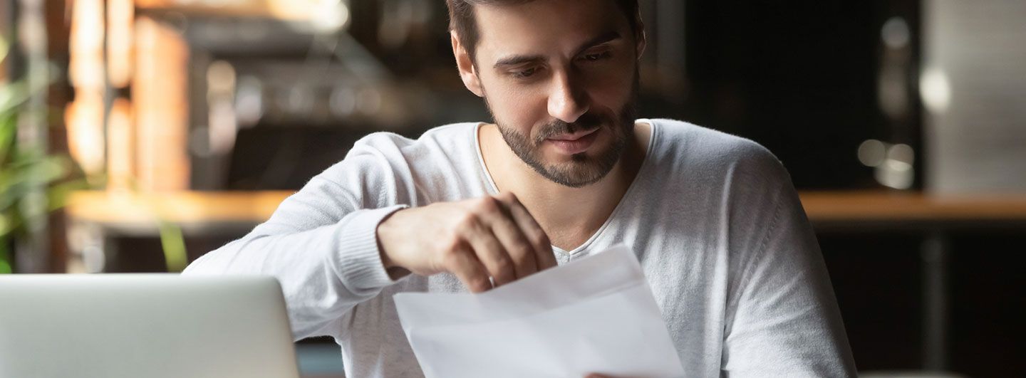 Man opening a letter