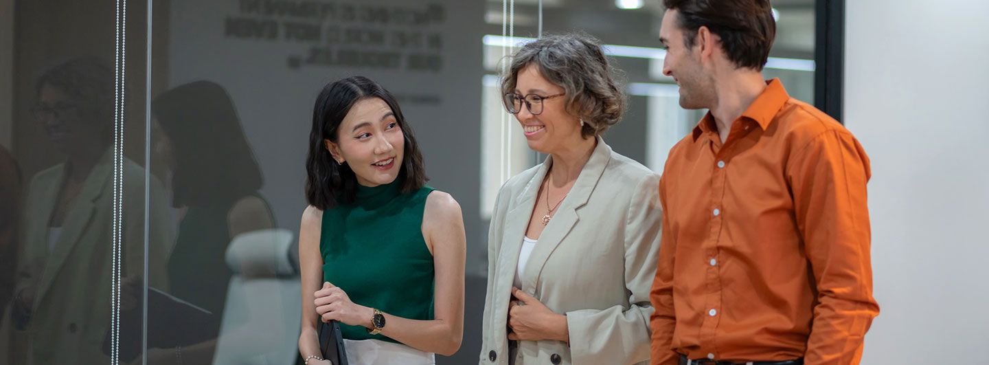 Three people talking and walking